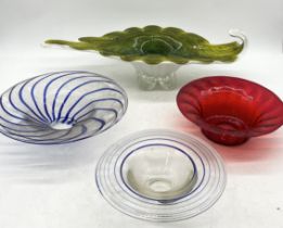 A large art glass centrepiece along with two blue swirl bowls and one other