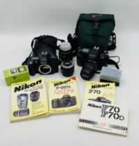A Nikon F80 SLR camera, along with a Nikon F70, with a Nikon AF Micro Nikkor 60mm lens, a Nikon AF