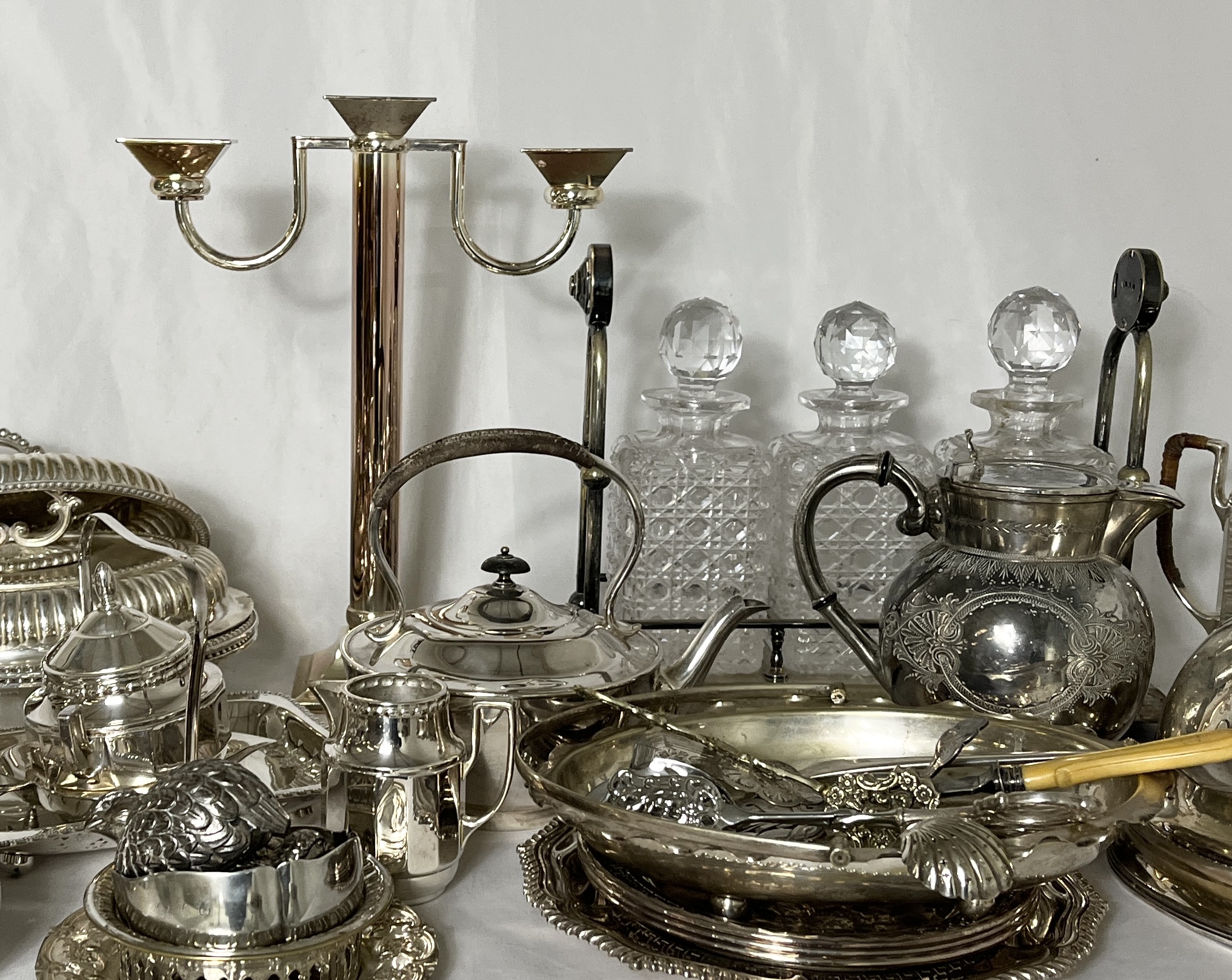 A large collection of silver plated items including cloches, Fink