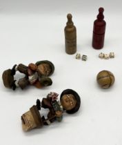 A small collection of items including two carved stoppers, miniature skittles and miniature dice