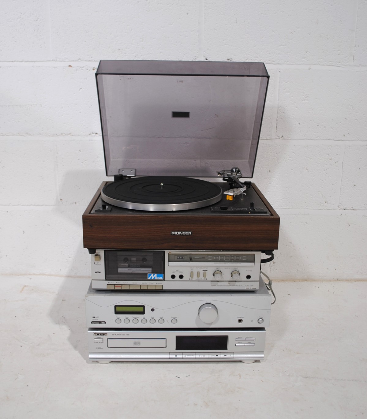A vintage stacking hi-fi system, comprising a Pioneer PL-12D belt-drive turntable, Sharp RT-12