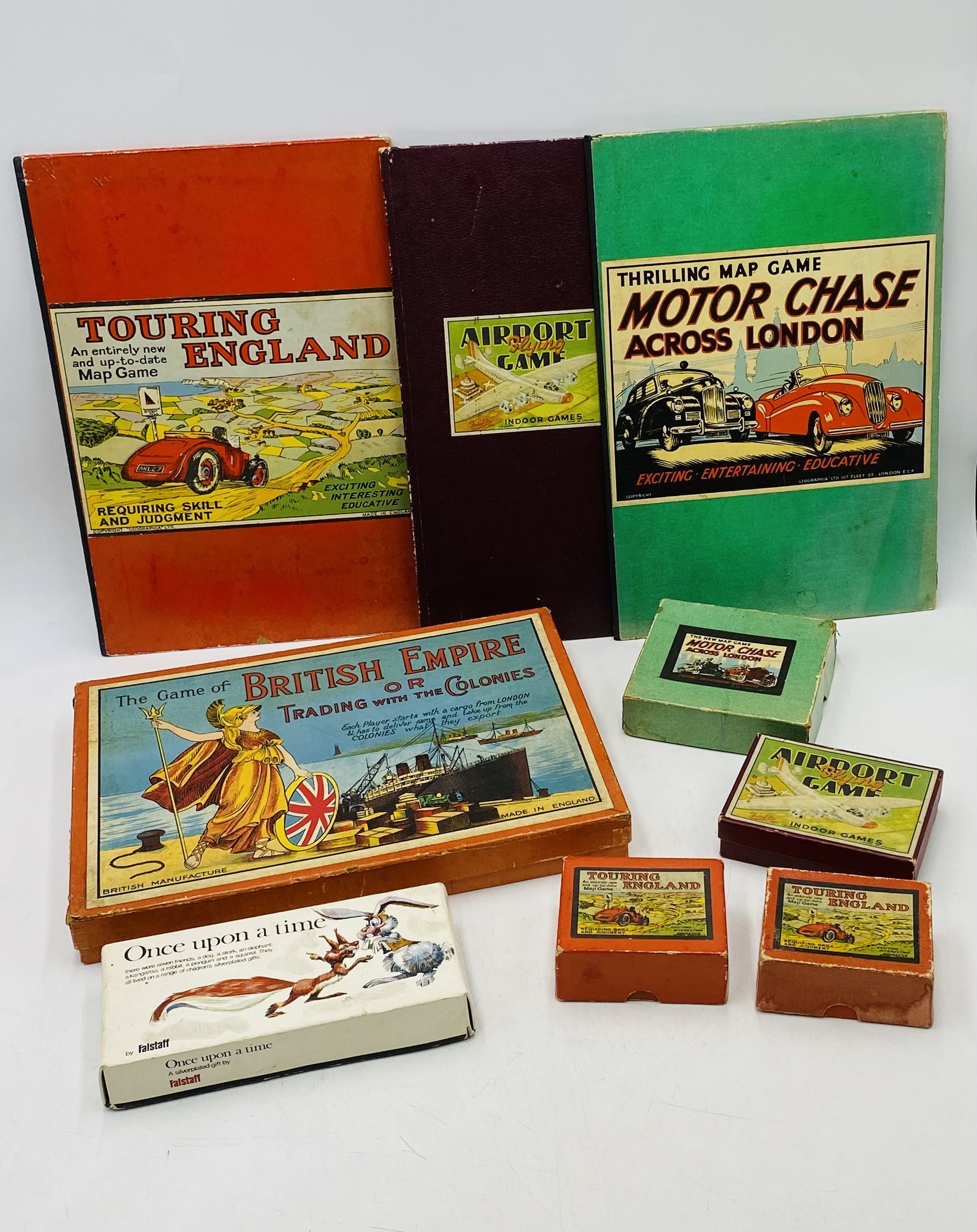 A collection of vintage games relating to transport, including Motor Chase Across London, Touring