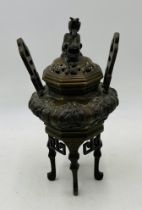 An 19th Century Chinese bronze censer, with dragon finial - one handle loose - height 28cm