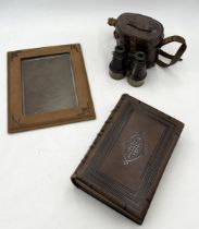 A cased set of T French & Son binoculars dated 1916 along with a vintage suede photo frame and
