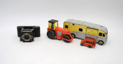 An Ensign Midget camera, along with three diecast toy vehicles including Dinky