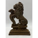 An antique cast iron doorstop in the form of a lion