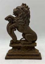 An antique cast iron doorstop in the form of a lion