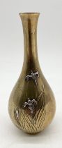 A Meiji period Japanese bronze vase decorated with flowers detailed in silver, character marks to