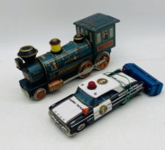 Two Japanese tinplate vehicles including a Western Locomotive and American Highway Patrol Police