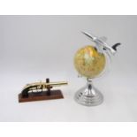 An Art Deco style globe, with chrome aeroplane finial and mounts, along with an ornamental brass