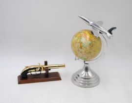 An Art Deco style globe, with chrome aeroplane finial and mounts, along with an ornamental brass