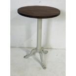 A bistro style table with painted cast iron industrial base.