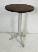 A bistro style table with painted cast iron industrial base.