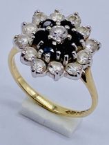 A diamond and sapphire cluster ring set in 14ct gold, size J