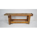 A rustic pine workbench on wheels, with a Record No 53 vice and a clamp - length (including vice &