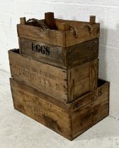Three vintage wooden crates, one marked "Eggs" (both sides) with rope handles, one marked "J&F