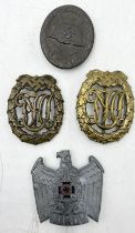 A German WWII wound badge marked to reverse 107, two DRL sports badges along with an NSKOV cap
