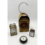 A Chalwyn road/railway lamp, painted yellow, along with a Metamec carriage clock and two others