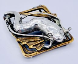 An SCM buckle depicting a flying fish, signed to reverse Hodel