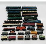 A collection of model railway OO gauge carriages, rolling stock and dummy cars including Tri-ang,