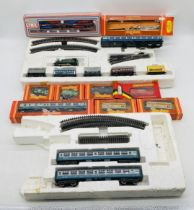 A collection of model railway OO gauge rolling stock, carriages, track and single locomotive.