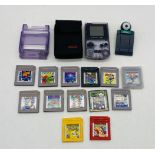 A Nintendo Gameboy Colour handheld gaming console in soft carry case, along with a selection of