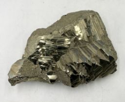 A very large Iron Pyrite crystal specimen with distinct formations across the centre of the piece.