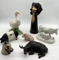 A collection of ceramics including Chinese water buffalo, continental bisque cow and calf, vase in