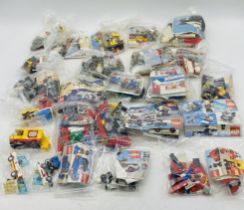 A collection of various unboxed Lego sets, mainly vehicles - sets bagged, some pre-built with