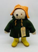 A vintage Gabrielle Designs Ltd "Paddington Bear" in orange hat, green coat and yellow boots, with