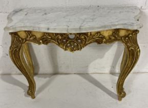 A low marble topped hall table with gilded base