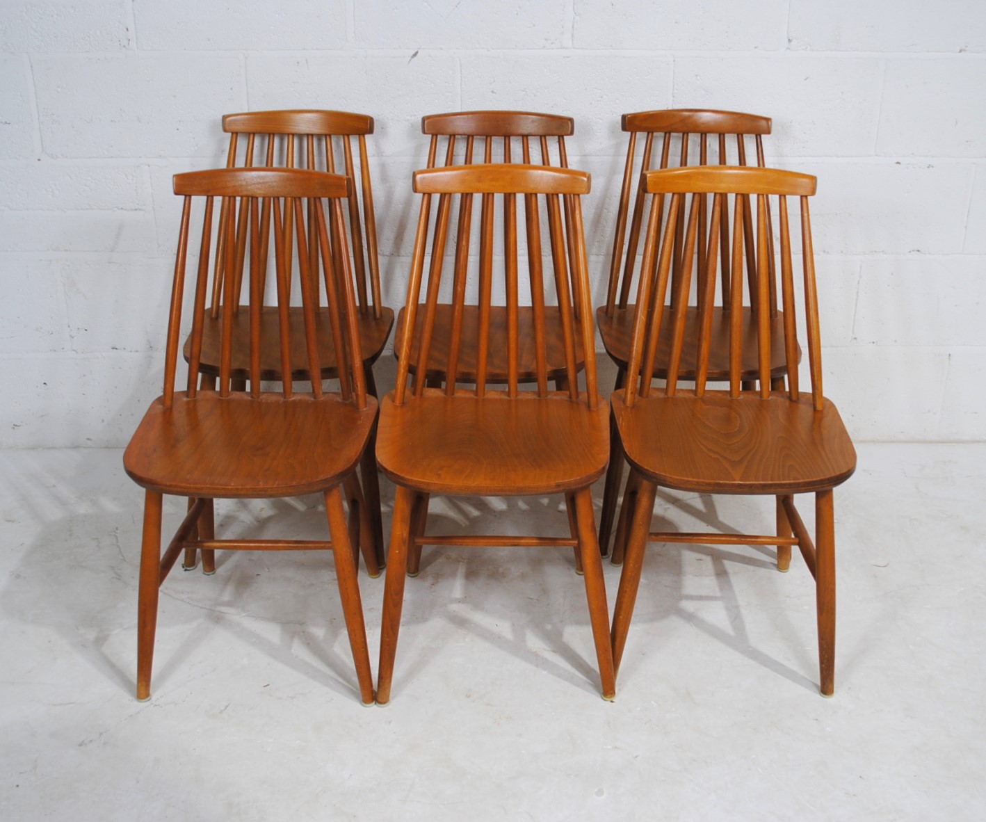 A set of six Ercol style stick-back chairs