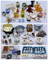 A collection of dolls house accessories including coffee sets, framed portraits, bowl/jug set,