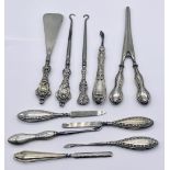 A collection of silver handled items including glove stretchers, shoe horn, paper knife etc.