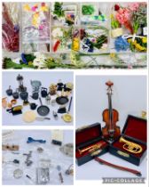 A collection of dolls house accessories including a container of flowers, musical instruments and