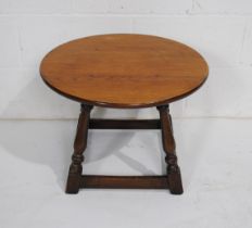 A small circular oak coffee table - diameter 55cm, height 40cm