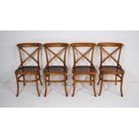 A set of four 20th Century bentwood cross-back chairs, with cane seats