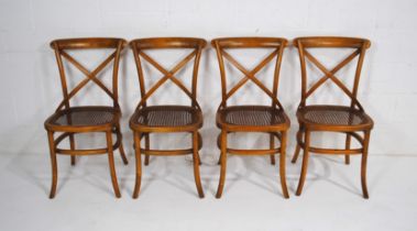 A set of four 20th Century bentwood cross-back chairs, with cane seats