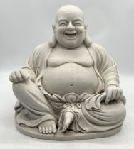 A faux marble laughing Buddha in seated position - height approx. 43cm