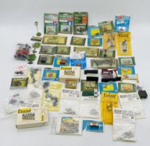 A collection of model railway OO gauge scenery including passengers, animals. sewage pipes. signals.