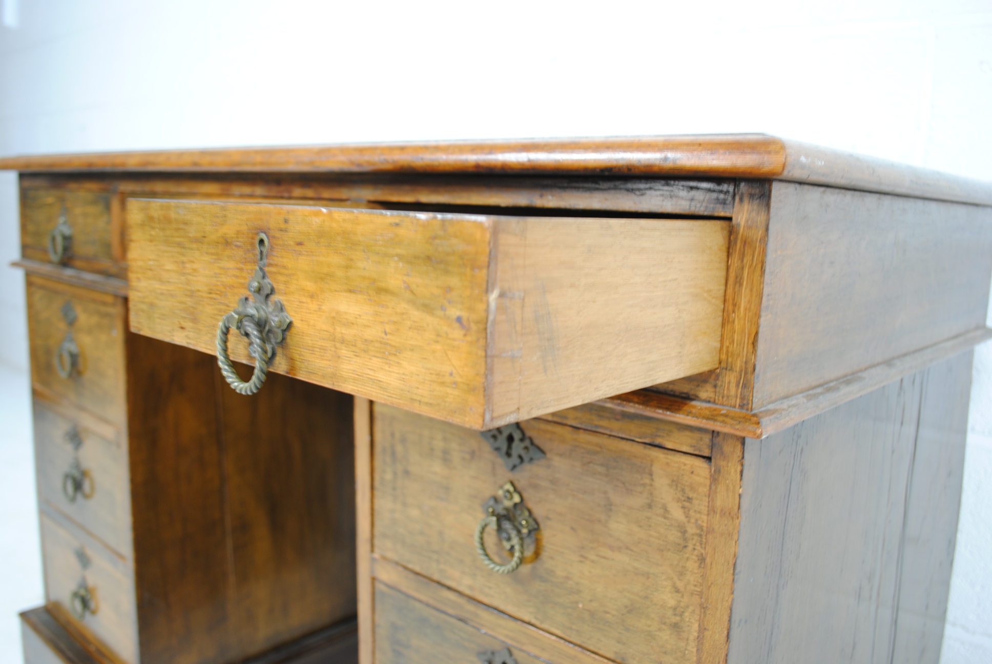A Victorian oak kneehole writing desk, with green leather inset top and nine drawers - length 106cm, - Image 6 of 9