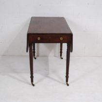 A Victorian mahogany Pembroke table, with single drawer, raised on turned legs with brass castors