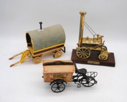 A brass model 'Stephens Rocket', along with a wooden model shepherds hut and a bakers bike