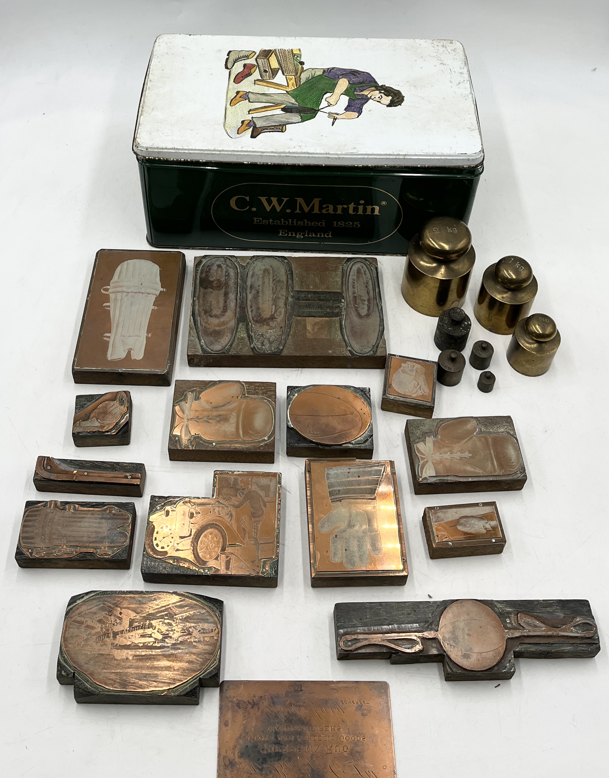 A collection of weights and vintage printing blocks mainly on the theme of sport