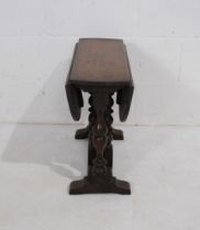 A small antique oak dropleaf table - height 48.5cm