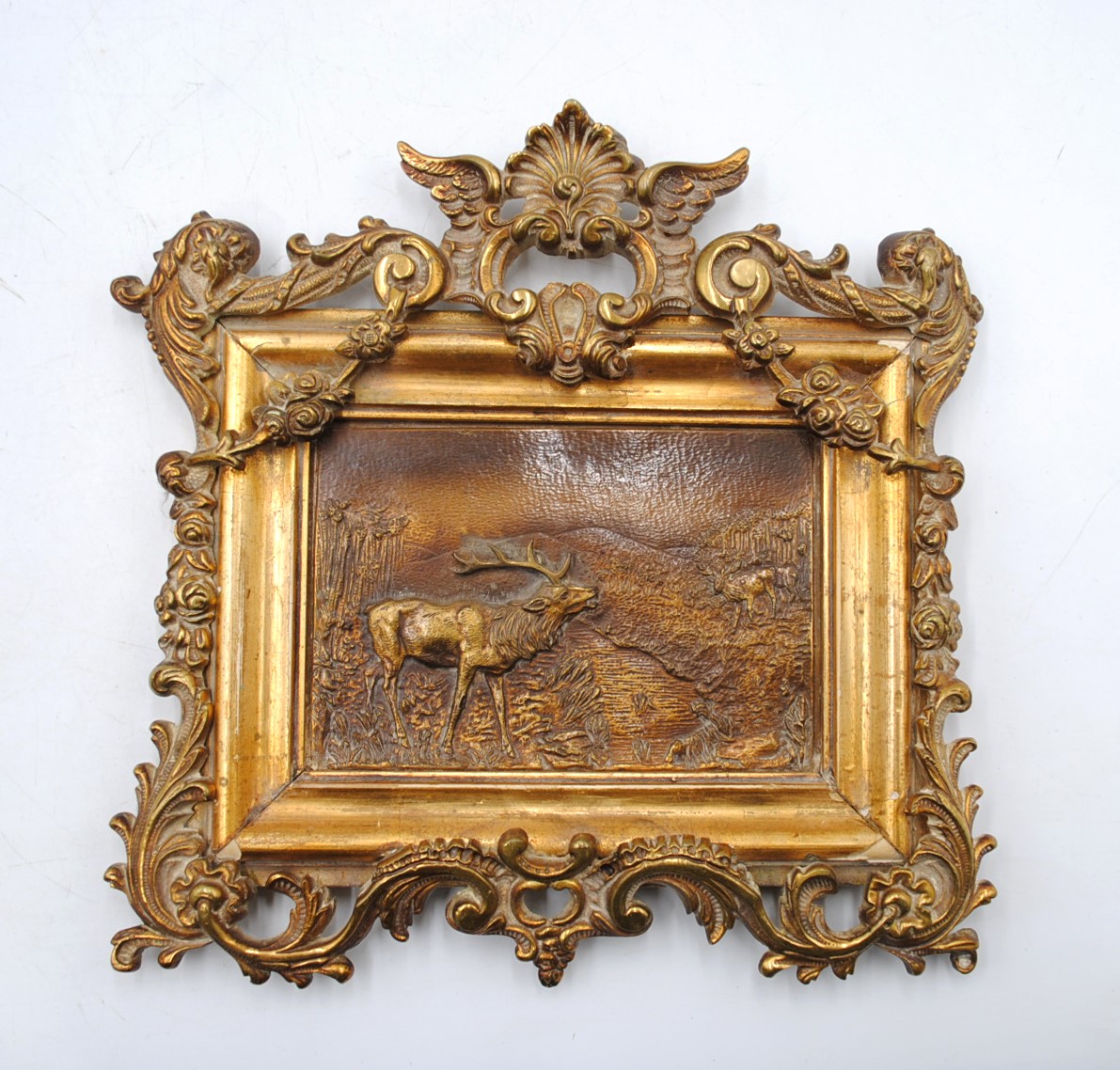 A framed bronze plaque of deer by a river - 25cm x 25cm