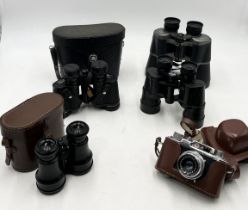 A collection of binoculars including a pair of West German Optolyth Alpin 10 x40 binoculars