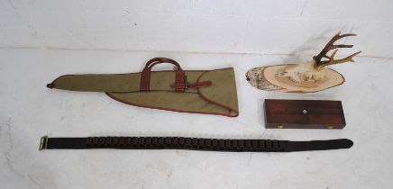 A 'Sacar' gun case, along with a leather cartridge belt, boxed gun cleaning kit and a mounted deer