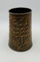 A Newlyn style copper vase with repousse Arts and Crafts decoration - height 19cm