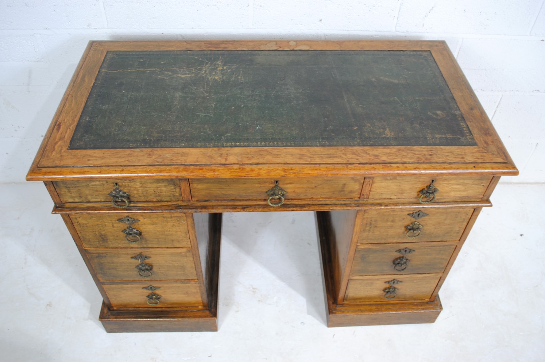 A Victorian oak kneehole writing desk, with green leather inset top and nine drawers - length 106cm, - Image 4 of 9